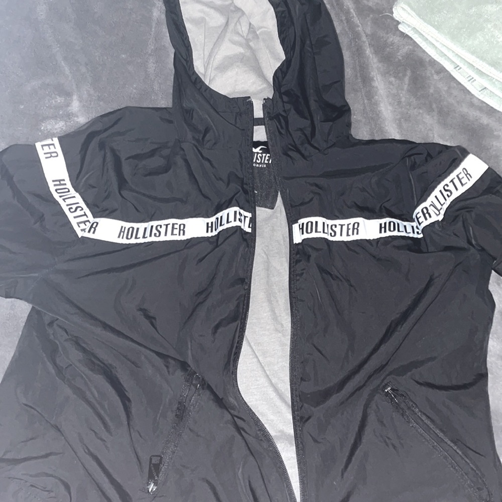Black windbreaker.